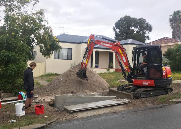 Bentley residential subdivision in progress with plumbers at work