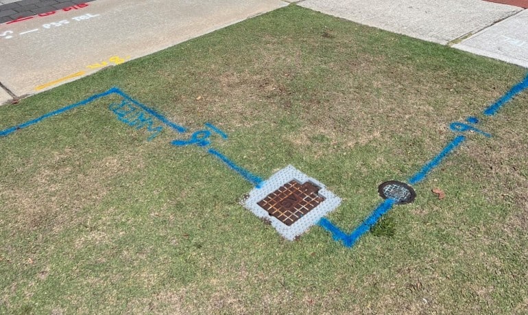 standard colours for underground utility surveys painted on grass and pavement